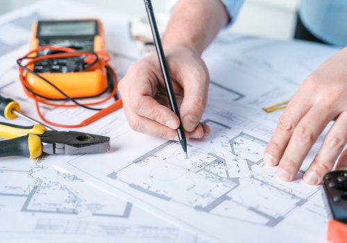 Man,Repairer,Making,Electricity,Project,In,House.repairs,Planning.drawing,diagrams,plan,Of,Electrification