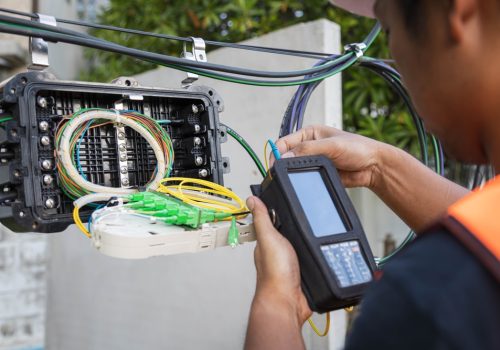Engineer,Or,Technician,Checking,Fiber,Optic,Cables,In,Internet,Splitter